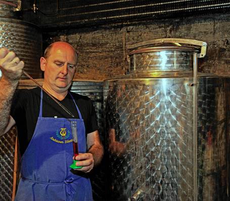 Modern wine cellar with wooden barrels at Sonngart winery in South Tyrol