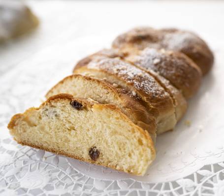 Modern alpine hotel room with double bed, wooden furniture, and balcony in South Tyrol